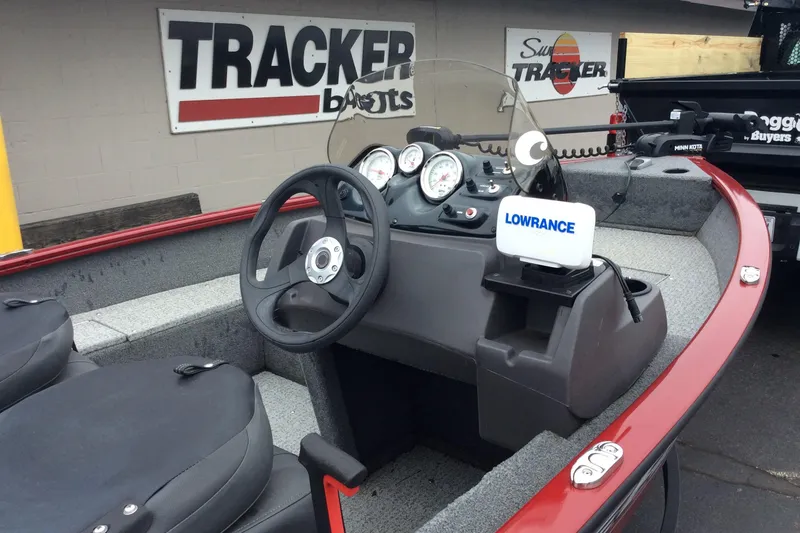 Slide: The Image of 2021 Tracker Super Guide V-16 SC boat interior with steering wheel and Lowrance device. - 4