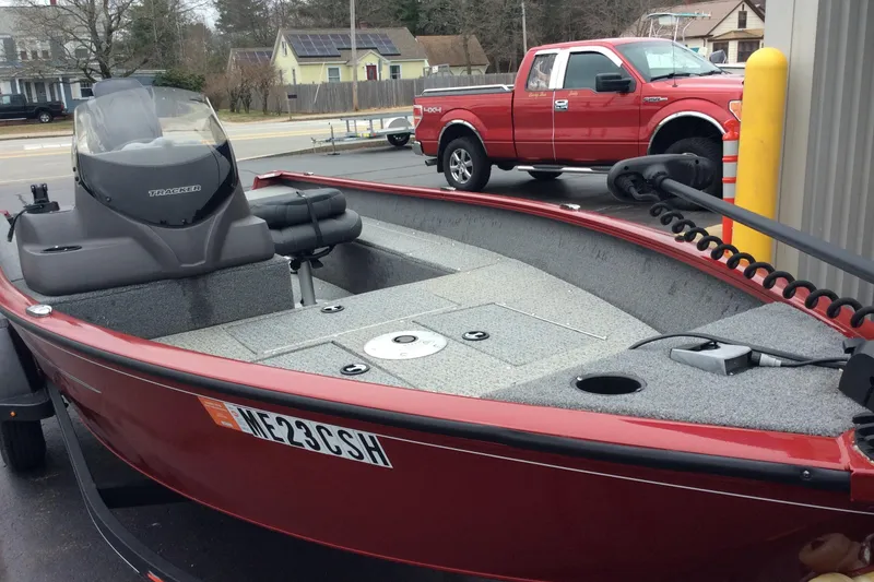 Slide: The Image of 2021 Tracker Super Guide V-16 SC boat in parking lot, red exterior, gray interior. - 5