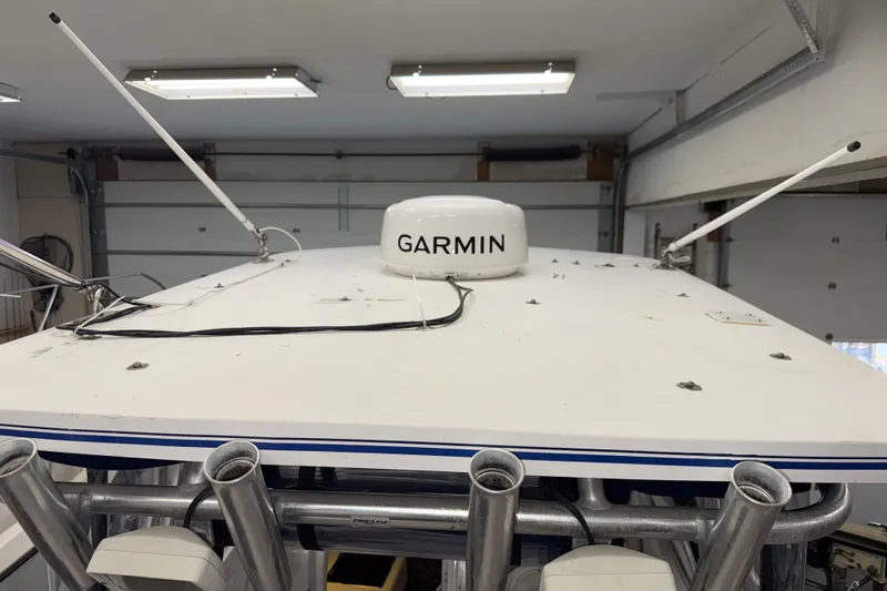 Slide: The Image of 2002 Pro-Line 260 Walkaround boat with Garmin radar on the roof in a garage. - 10