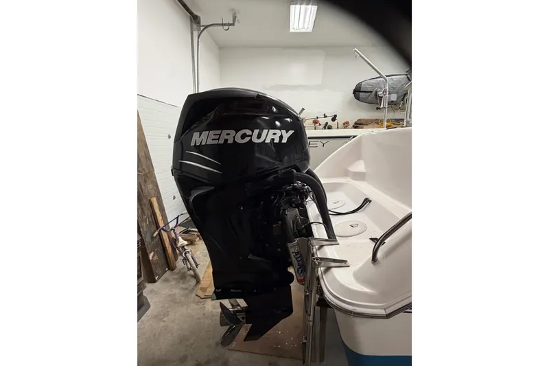 Slide: The Image of 2002 Pro-Line 260 Walkaround with Mercury outboard motor in a garage setting. - 12