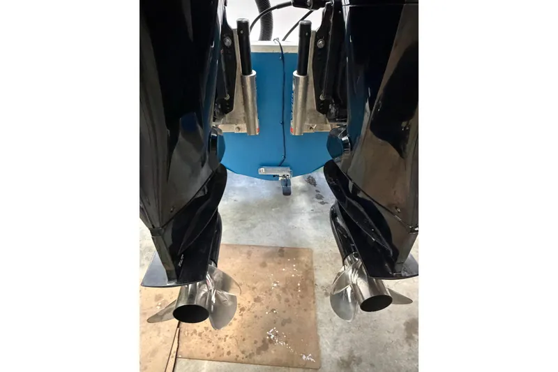 Slide: The Image of 2002 Pro-Line 260 Walkaround boat with dual outboard motors in a garage setting. - 15