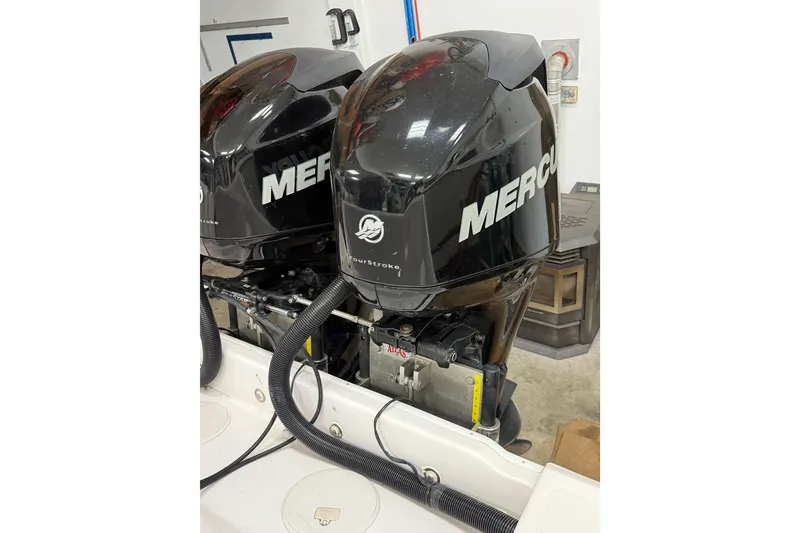 Slide: The Image of Twin Mercury outboard engines on a 2002 Pro-Line 260 Walkaround boat. - 17