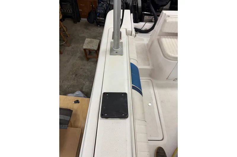 Slide: The Image of 2002 Pro-Line 260 Walkaround boat interior, featuring seating and deck details. - 19