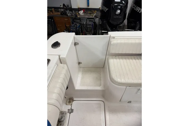 Slide: The Image of 2002 Pro-Line 260 Walkaround boat interior with seating and storage compartments. - 20