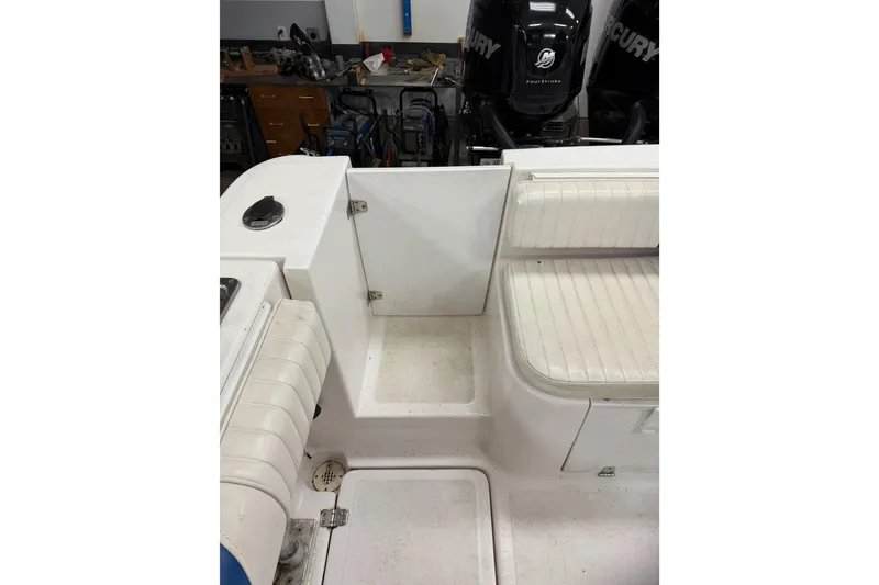 Slide: The Image of 2002 Pro-Line 260 Walkaround boat interior with seating and Mercury engines. - 21