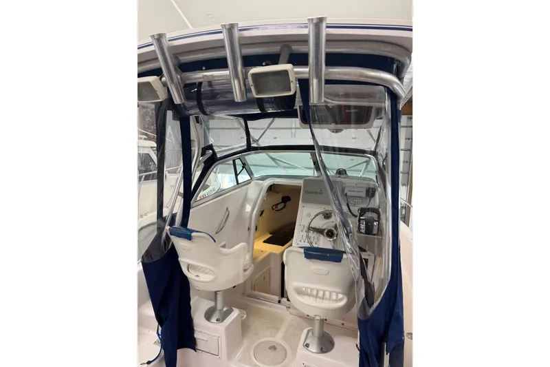 Slide: The Image of 2002 Pro-Line 260 Walkaround boat interior with helm, seats, and navigation equipment. - 23