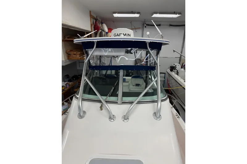 Slide: The Image of 2002 Pro-Line 260 Walkaround boat with Garmin equipment in a garage setting. - 27