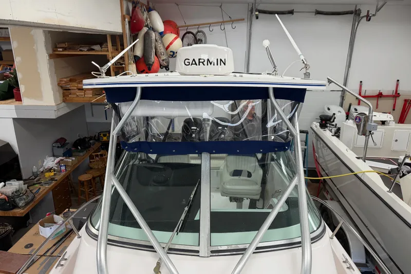 Slide: The Image of 2002 Pro-Line 260 Walkaround boat in garage with Garmin equipment and nautical gear. - 28