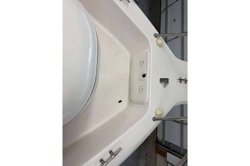 Slide: The Image of 2002 Pro-Line 260 Walkaround boat deck with storage compartments and railing. - 29