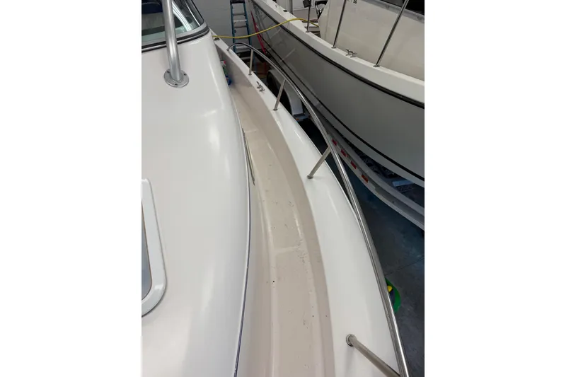 Slide: The Image of 2002 Pro-Line 260 Walkaround boat deck with railing in storage. - 32