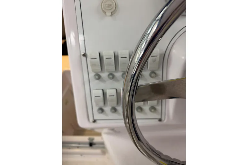 Slide: The Image of Control panel and steering wheel of 2002 Pro-Line 260 Walkaround boat. - 36