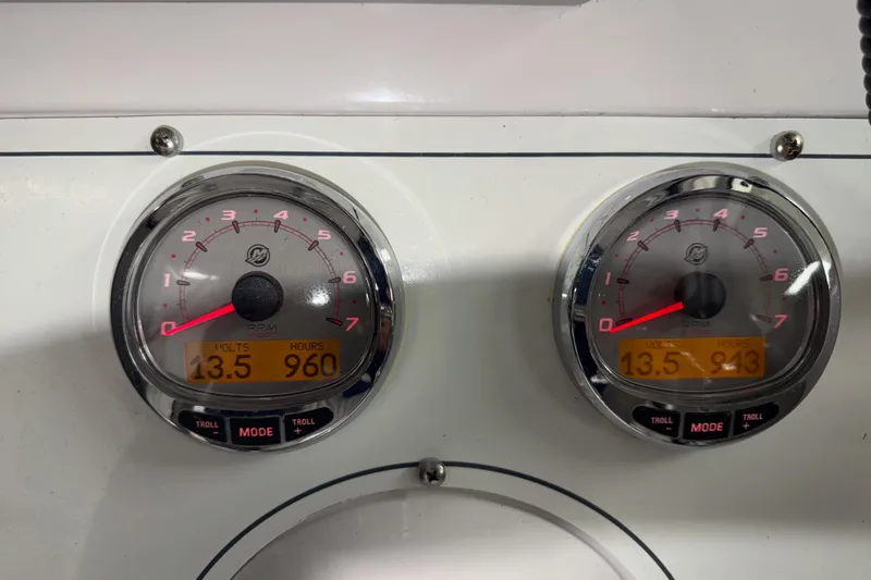 Slide: The Image of Close-up of Pro-Line 260 Walkaround 2002 boat gauges displaying volts and engine hours. - 37