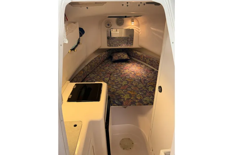 Slide: The Image of Cozy cabin interior of 2002 Pro-Line 260 Walkaround boat with patterned bedding. - 39