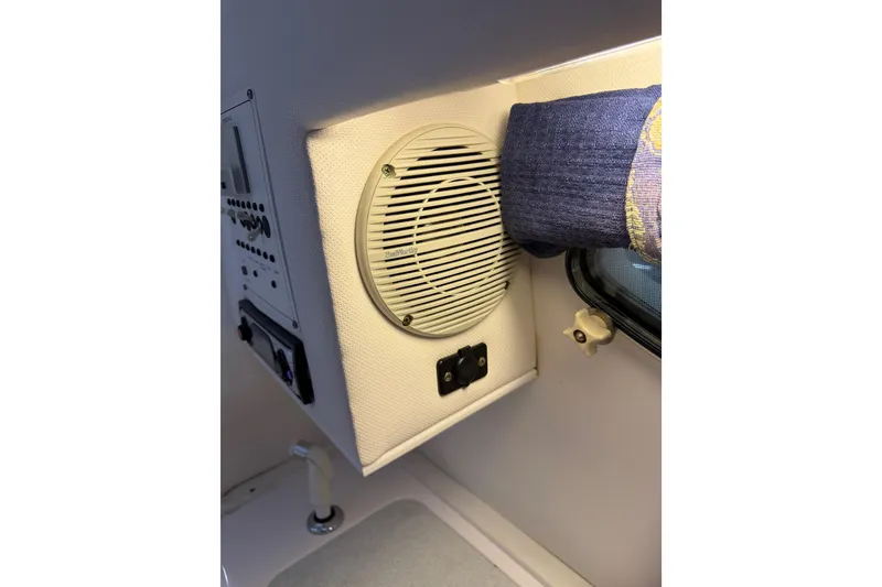 Slide: The Image of Interior of 2002 Pro-Line 260 Walkaround boat featuring speaker and control panel. - 42