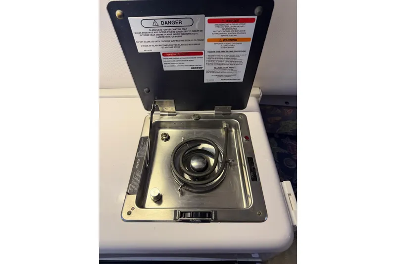 Slide: The Image of 2002 Pro-Line 260 Walkaround boat stove with safety instructions displayed. - 43