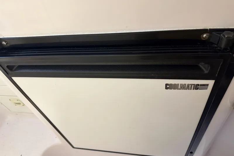 Slide: The Image of Coolmatic fridge inside 2002 Pro-Line 260 Walkaround boat cabin. - 51