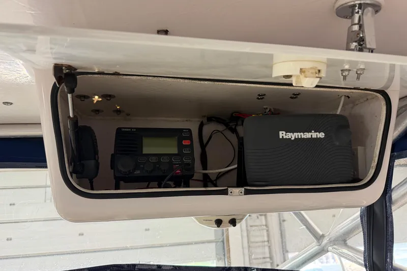 Slide: The Image of 2002 Pro-Line 260 Walkaround electronics compartment with Raymarine and Uniden equipment. - 59
