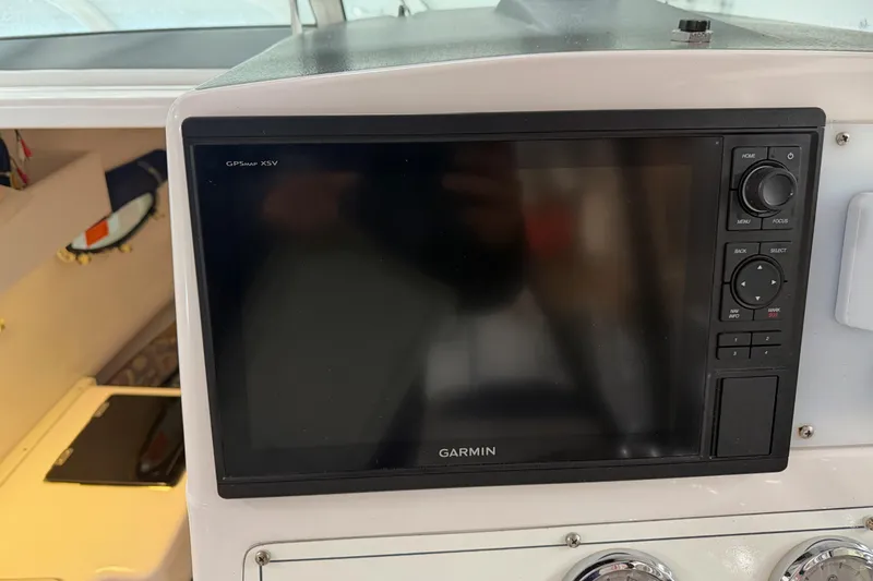 Slide: The Image of Garmin GPS display on 2002 Pro-Line 260 Walkaround boat dashboard. - 61