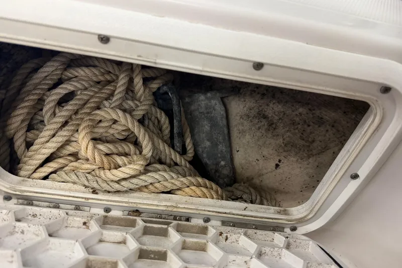 Slide: The Image of Coiled rope in storage compartment of 2002 Pro-Line 260 Walkaround boat. - 63
