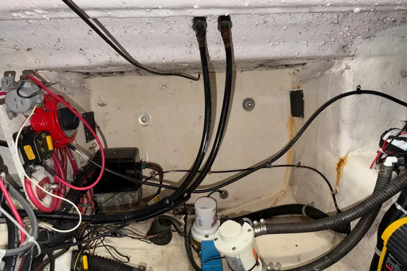 Slide: The Image of Engine compartment of a 2002 Pro-Line 260 Walkaround boat, showing wiring and hoses. - 67
