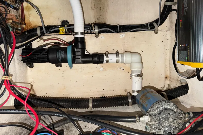 Slide: The Image of 2002 Pro-Line 260 Walkaround boat wiring and plumbing system in the engine compartment. - 69