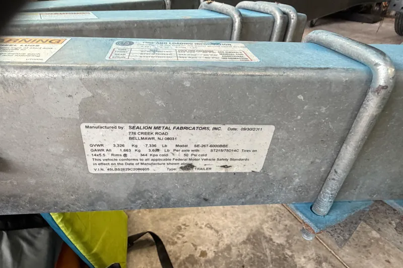 Slide: The Image of Label on metal trailer frame by Sealion Metal Fabricators, detailing specifications and safety standards. - 70