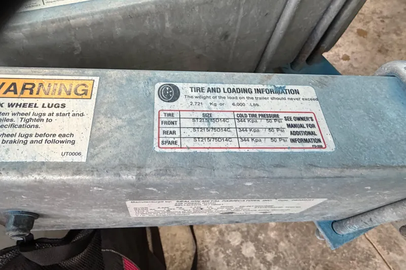 Slide: The Image of Warning label and tire information on a 2002 Pro-Line 260 Walkaround trailer. - 71