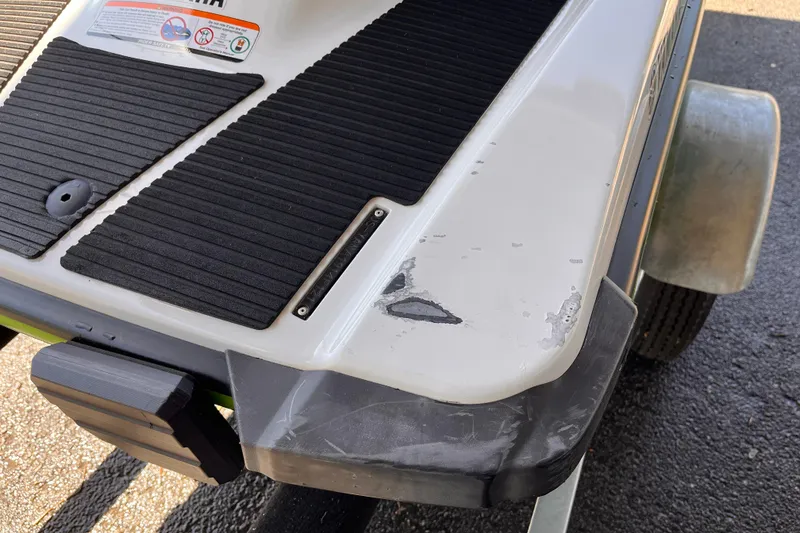 Slide: The Image of 2021 Yamaha WaveRunner EX Deluxe rear with visible wear and black traction mats. - 5