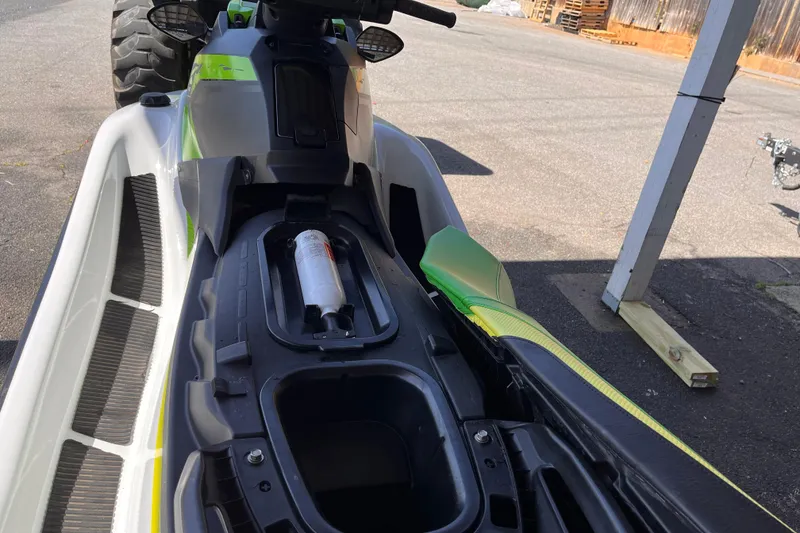 Slide: The Image of 2021 Yamaha WaveRunner EX Deluxe with open storage compartment, parked outdoors. - 6