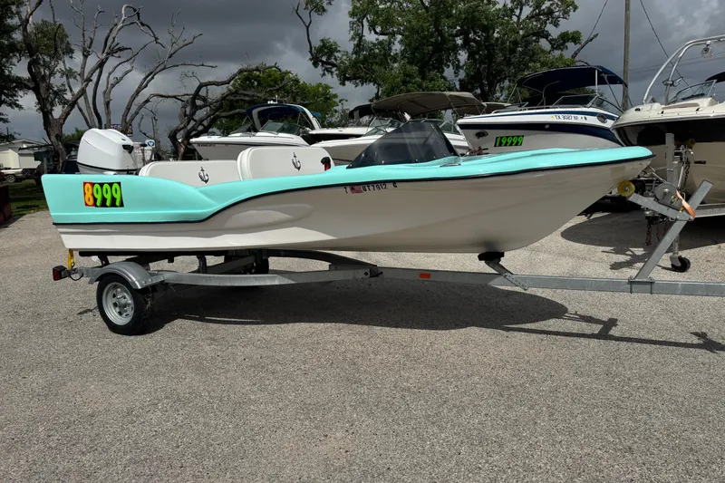 The Image of 1959 Redfish 14 Shark boat on trailer, turquoise and white design, price tag visible. - 1