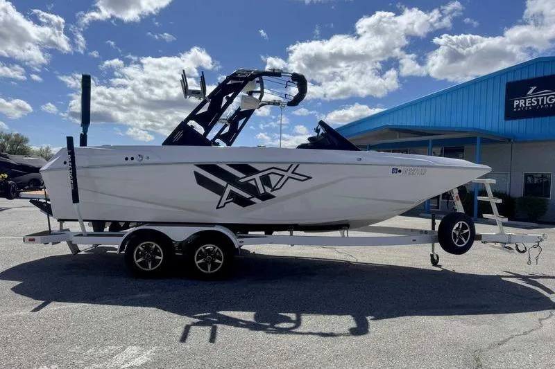 Slide: The Image of 2021 ATX Type 22s boat on trailer, parked outside Prestige Water Sports. - 10