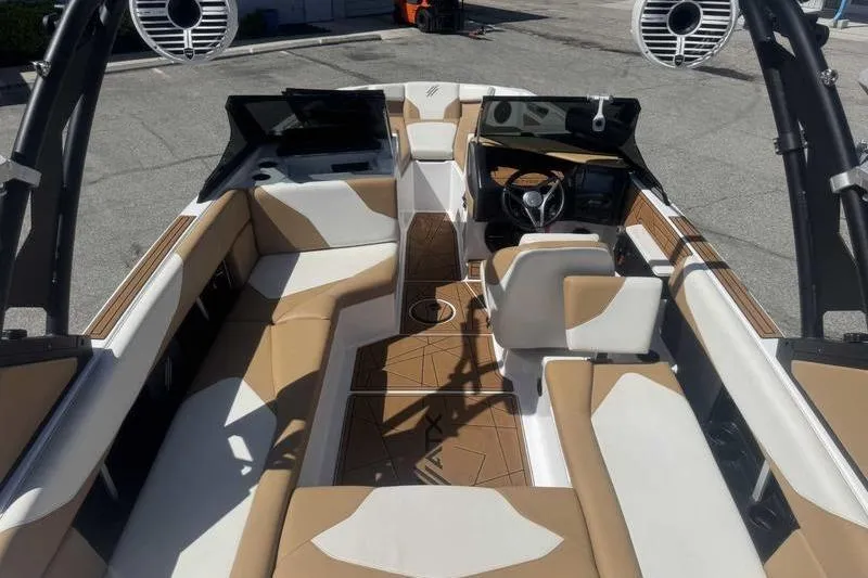 Slide: The Image of 2021 ATX Type 22s boat interior with tan and white seating, modern dashboard. - 11