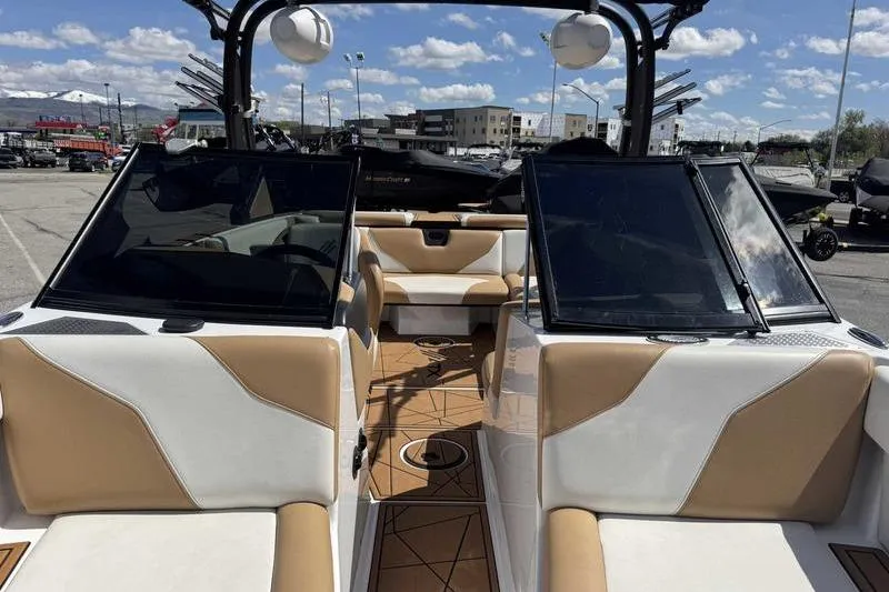 Slide: The Image of 2021 ATX Type 22s boat interior with tan and white seating, parked outdoors. - 15