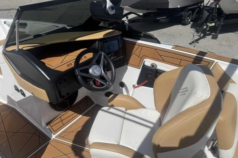 Slide: The Image of 2021 ATX Type 22s boat interior with tan and white seating, steering wheel, and dashboard. - 4
