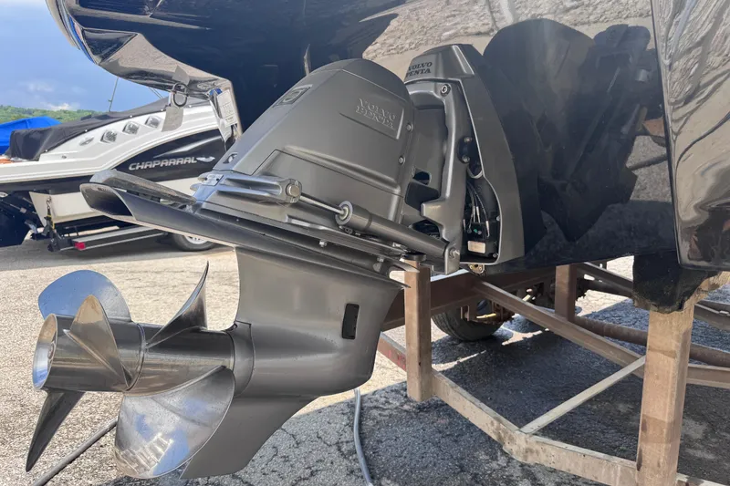 Slide: The Image of 2025 Crownline Eclipse E235 boat with Volvo Penta outdrive, displayed on a stand. - 10