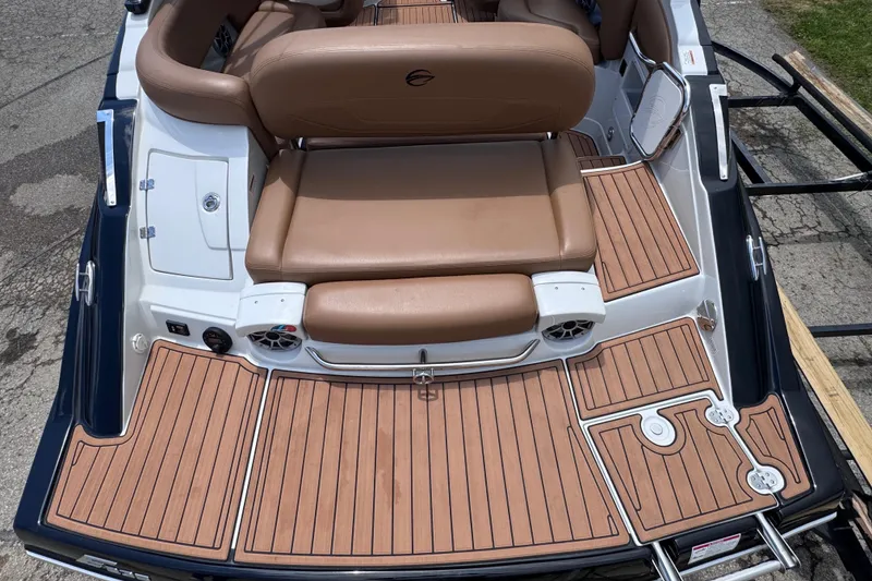 Slide: The Image of 2025 Crownline Eclipse E235 boat with teak-style deck and tan seating. - 12