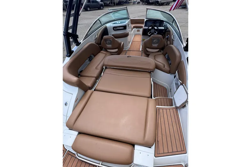 Slide: The Image of 2025 Crownline Eclipse E235 boat interior with tan seating and wood accents. - 14
