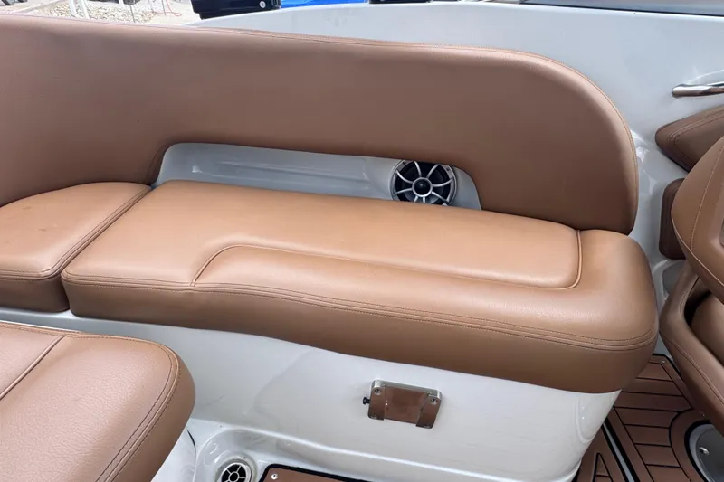Slide: The Image of 2025 Crownline Eclipse E235 boat interior with tan leather seating and speaker. - 17