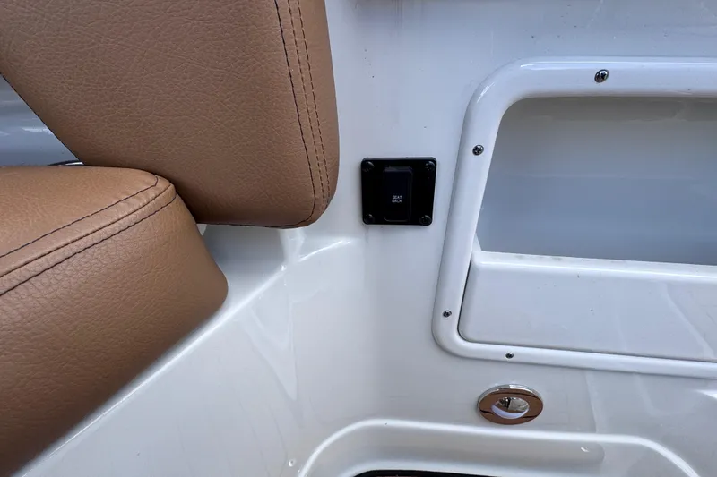 Slide: The Image of 2025 Crownline Eclipse E235 boat interior with brown leather seat and control panel. - 19