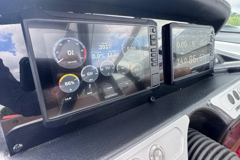 Slide: The Image of Dashboard of 2025 Crownline Eclipse E235 boat with Garmin displays showing engine metrics. - 23