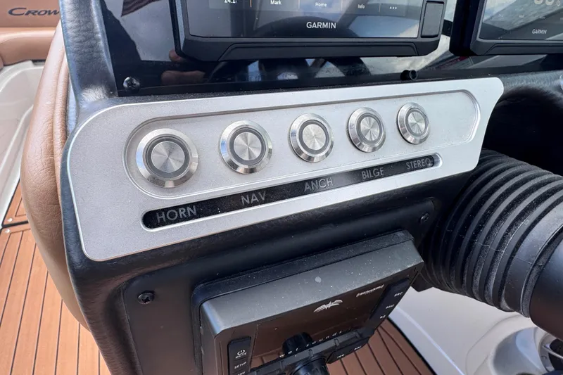 Slide: The Image of Control panel of 2025 Crownline Eclipse E235 boat with labeled buttons and Garmin display. - 24