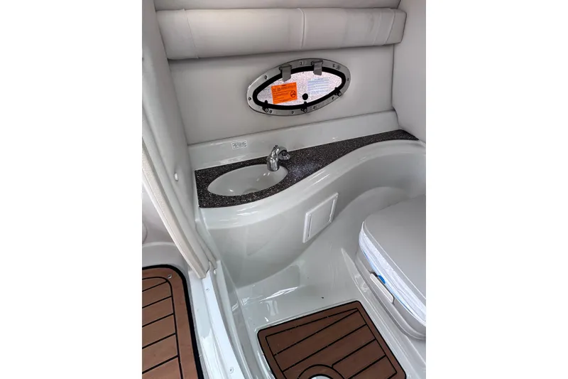 Slide: The Image of Interior of 2025 Crownline Eclipse E235 boat, featuring a compact sink and seating area. - 30