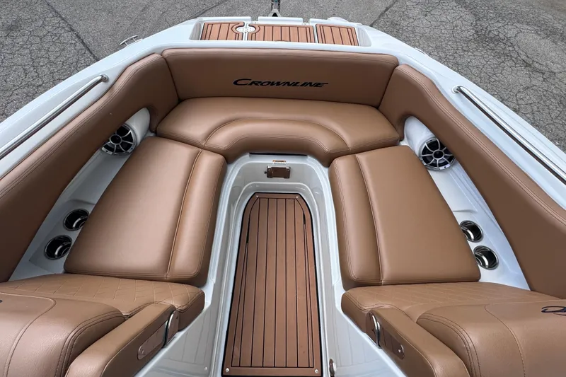Slide: The Image of 2025 Crownline Eclipse E235 boat interior with tan leather seating and wood accents. - 31