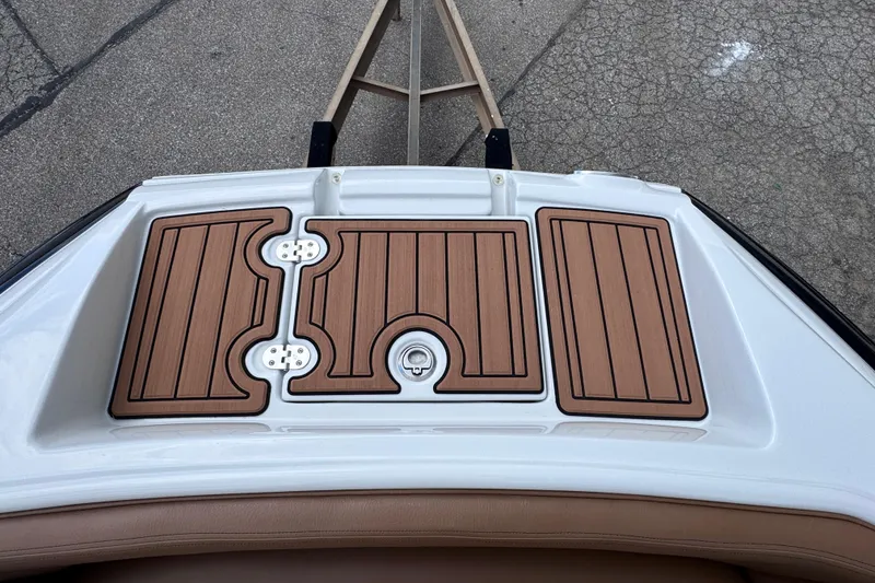 Slide: The Image of 2025 Crownline Eclipse E235 boat deck with teak-style flooring, showcasing elegant design. - 33