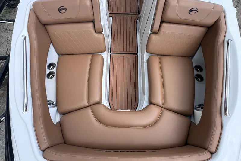 Slide: The Image of 2025 Crownline Eclipse E235 boat interior with tan leather seating and wood flooring. - 34