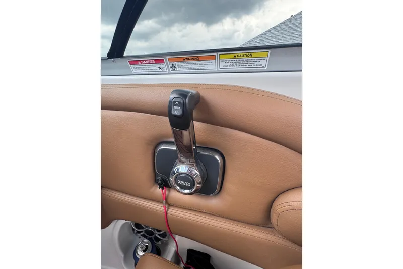Slide: The Image of Throttle control of 2025 Crownline Eclipse E235 boat with warning labels visible. - 37