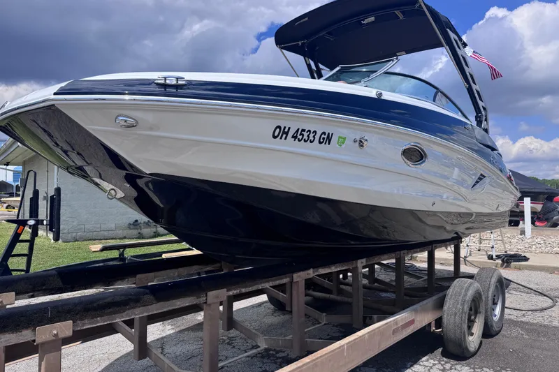 Slide: The Image of 2025 Crownline Eclipse E235 boat on trailer under cloudy sky. - 6