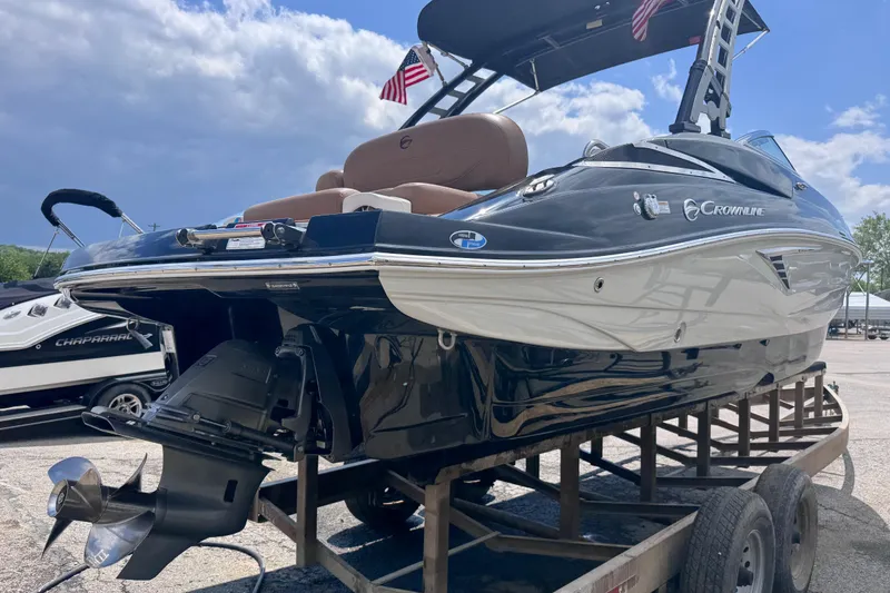 Slide: The Image of 2025 Crownline Eclipse E235 boat on trailer, featuring sleek design and powerful engine. - 8