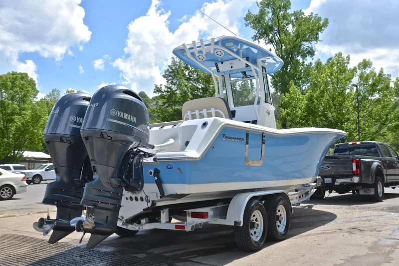 Slide: The Image of 2021 Tidewater 256 CC Adventure boat with dual Yamaha engines on a trailer. - 15