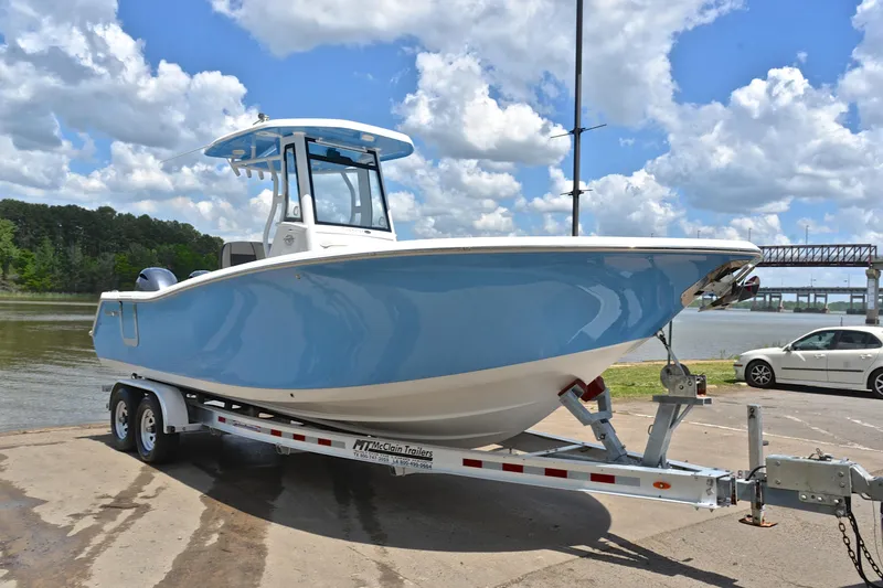 Slide: The Image of 2021 Tidewater 256 CC Adventure boat on trailer by a scenic river. - 17